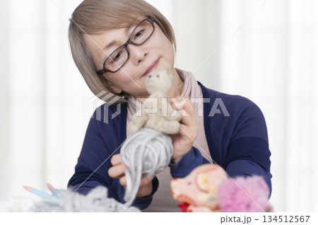 リビングでぬい活をするシニア女性 リビングでぬい活をするシニア女性 134512567