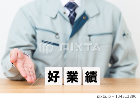 好業績のブロックと作業着を着たミドル男性ビジネスマン 134512890