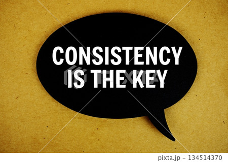 Consistency Is The Key text with speech bubble top view on paper craft background 134514370