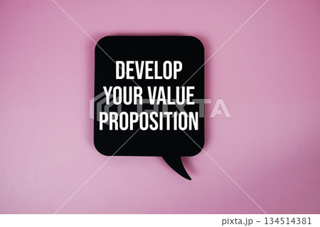 Develop Your Value Proposition text with speech bubble top view on pink background Develop Your Value Proposition text with speech bubble top view on pink background 134514381