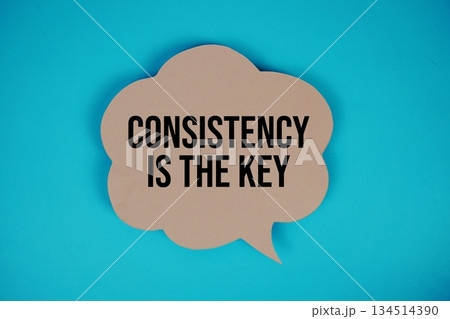 Consistency Is The Key text with speech bubble top view on blue background 134514390