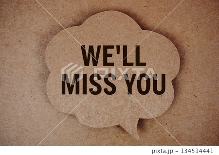 We'll Miss You text with speech bubble on paper craft background We'll Miss You text with speech bubble on paper craft background 134514441