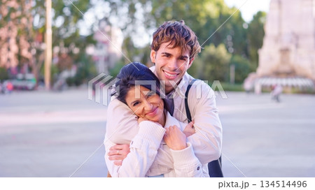 Happy diverse couple embracing outdoors in city Happy diverse couple embracing outdoors in city 134514496