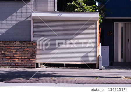 A closeup shot of automatic metal roller door used in factory, storage, garage, and industrial warehouse. The corrugated and foldable metal sheet offer space saving and provide urban and rustic feel 134515174