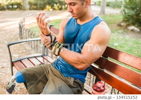 Venezuelan amputee athlete sitting resting wrist Venezuelan amputee athlete sitting resting wrist 134515252