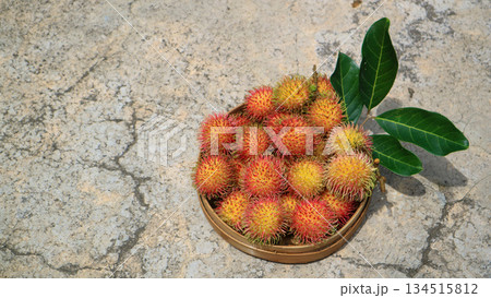 Rambutan fruit in basket on industrial minimalist background, Tropical fruit organic farming  134515812