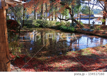 A beautiful pond in a Japanese garden by a temple on the grounds of the Chusonji Buddhist temple in Hiraizumi town of Iwate prefecture in Japan A beautiful pond in a Japanese garden by a temple on the grounds of the Chusonji Buddhist temple in Hiraizumi town of Iwate prefecture in Japan 134517160