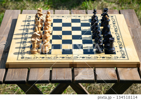 Chessboard with Chess Pieces on Table 134518114