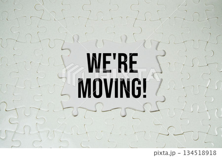 Jigsaw puzzle with a missing piece with "We're Moving!" on white background Jigsaw puzzle with a missing piece with "We're Moving!" on white background 134518918
