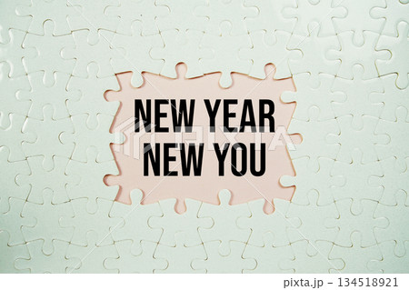 Jigsaw puzzle with a missing piece with "New Year New You" on pink background Jigsaw puzzle with a missing piece with "New Year New You" on pink background 134518921