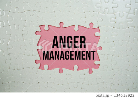 Jigsaw puzzle with a missing piece with "Anger Management" on pink background 134518922