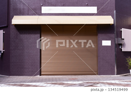 A closeup shot of automatic metal roller door used in factory, storage, garage, and industrial warehouse. The corrugated and foldable metal sheet offer space saving and provide urban and rustic feel 134519499