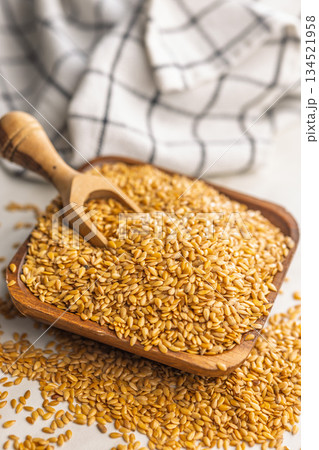 Golden linseed or flaxseed. Healthy flax seed in bowl on kitchen table. 134521958