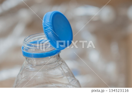 close up of innovative attached cap on empty pet bottle, merging convenience with ecology close up of innovative attached cap on empty pet bottle, merging convenience with ecology 134523116