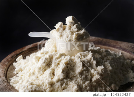 measuring spoon with dry sports protein on a board 134523427