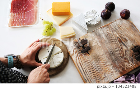 Girl Cutting Cheese On A Board For Cheese Board Girl Cutting Cheese On A Board For Cheese Board 134523488