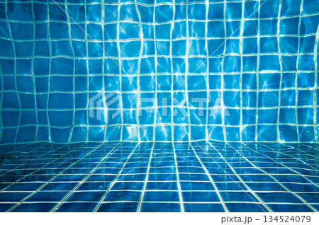 Abstract scene of moving water sprite under the water surface with blue square tiles background. 134524079