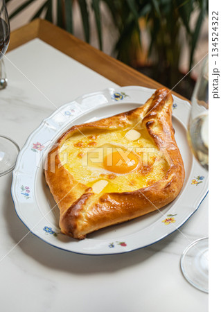 Adjarian khachapuri with egg and cheese Adjarian khachapuri with egg and cheese 134524322