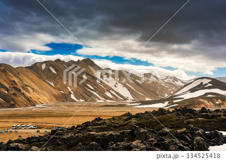 Scenic view of Landmannalaugar with volcanic mountain, black lava and clouds in Highlands of Iceland 134525418