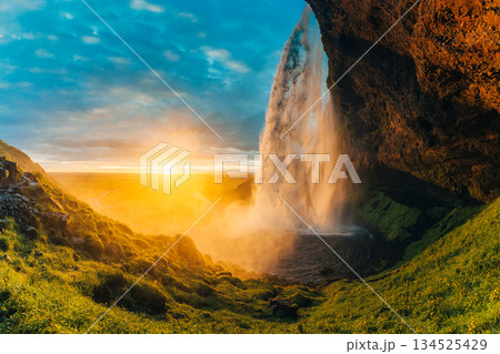 Beautiful sunset shining over Seljalandsfoss waterfall during summer in Iceland Beautiful sunset shining over Seljalandsfoss waterfall during summer in Iceland 134525429