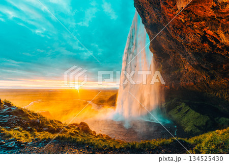 Beautiful sunset shining over Seljalandsfoss waterfall during summer in Iceland 134525430