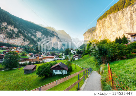 Rustic village in Lauterbrunnen valley with famous church and Staubbach Falls in the morning at Switzerland 134525447