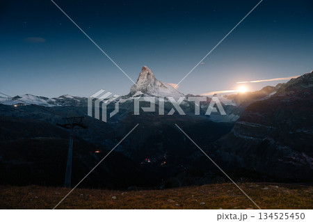 Matterhorn mountain with moonlight glowing in the dusk at Switzerland Matterhorn mountain with moonlight glowing in the dusk at Switzerland 134525450