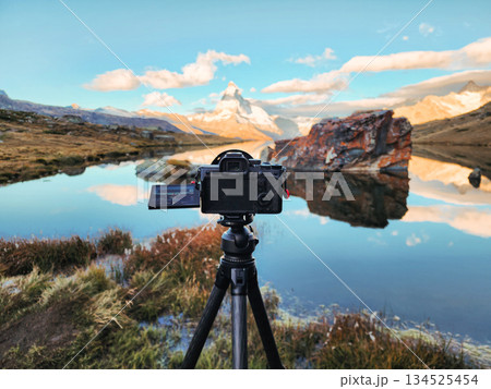 Camera set up capturing matterhorn peak reflection at Stellisee Lake in Zermatt Camera set up capturing matterhorn peak reflection at Stellisee Lake in Zermatt 134525454