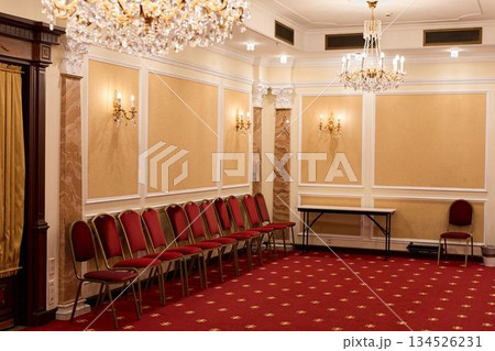 An Unused Opulent Ballroom Featuring Arranged Seating And Shimmering Chandeliers Awaiting Guests An Unused Opulent Ballroom Featuring Arranged Seating And Shimmering Chandeliers Awaiting Guests 134526231