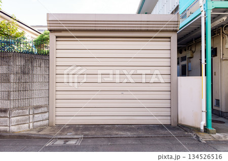 A closeup shot of automatic metal roller door used in factory, storage, garage, and industrial warehouse. The corrugated and foldable metal sheet offer space saving and provide urban and rustic feel 134526516