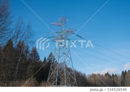 Tower of a high-voltage power line against the of blue sky and clouds 134526540