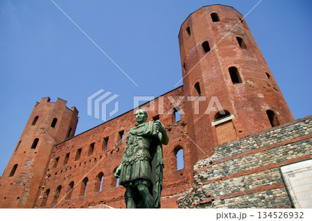 Turin, Italy, September 14, 2019: Julius Caesar Statue in Front of Porta Palatina Turin, Italy, September 14, 2019: Julius Caesar Statue in Front of Porta Palatina 134526932