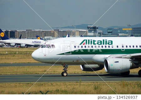 Frankfurt, Germany, July 09 2017: Italian Airbus A320 Taxiing Past Spotting Point Toward Runway Frankfurt, Germany, July 09 2017: Italian Airbus A320 Taxiing Past Spotting Point Toward Runway 134526937