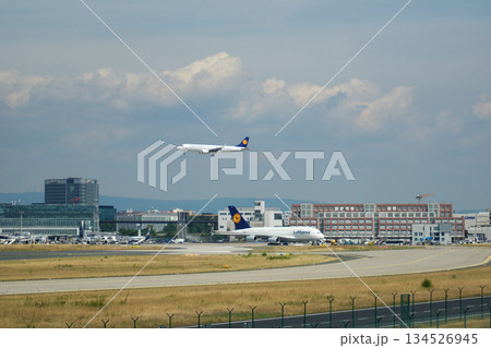 Frankfurt, Germany, July 09 2017: Parallel View of Landing A320 and Taxiing A380 Frankfurt, Germany, July 09 2017: Parallel View of Landing A320 and Taxiing A380 134526945