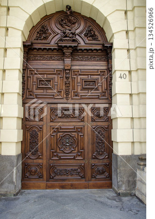 Turin, Italy, September 14, 2019: Ornate Wooden Entrance Door of Historic Building in City Center Turin, Italy, September 14, 2019: Ornate Wooden Entrance Door of Historic Building in City Center 134526966