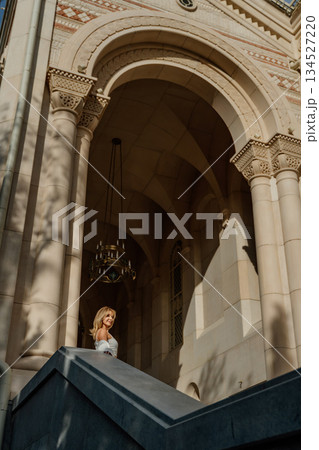Bride, Church, Stairs - A bride stands on the stairs of a church, looking towards the entrance. Bride, Church, Stairs - A bride stands on the stairs of a church, looking towards the entrance. 134527220