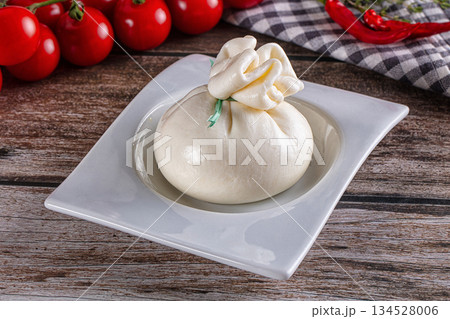 Fresh tasty burrata italian cheese Fresh tasty burrata italian cheese 134528006