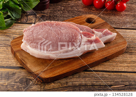 Raw pork steak over board 134528128