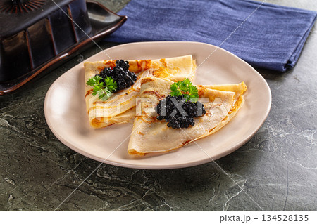 luxury pancake with black caviar 134528135