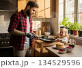 Father with prosthetic hand cook pancake at home 134529596
