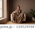 Woman meditate in armchair with cozy blanket 134529598
