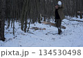 Winter bushcraft in the forest, Carrying logs 134530498