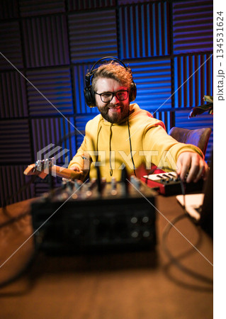 Sound engineer working at mixing panel in the boutique recording studio. 134531624