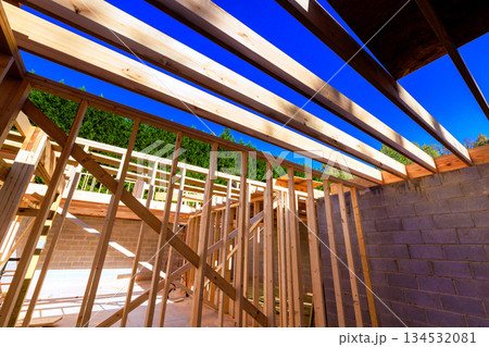 Wooden beams studs create framework new house at construction site Wooden beams studs create framework new house at construction site 134532081