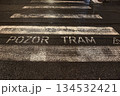 Pedestrian crossing at night through tram line, warning sign in Czech 134532421
