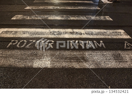 Pedestrian crossing at night through tram line, warning sign in Czech Pedestrian crossing at night through tram line, warning sign in Czech 134532421