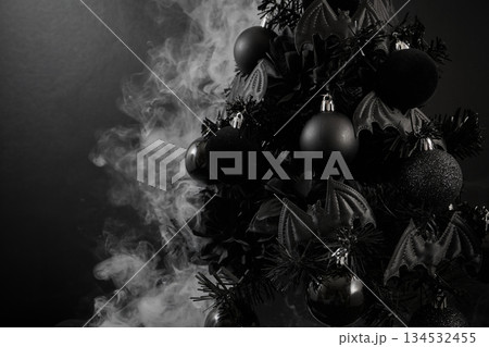 Gothic Christmas. A black Christmas tree adorned with dark ornaments and surrounded by mist Gothic Christmas. A black Christmas tree adorned with dark ornaments and surrounded by mist 134532455