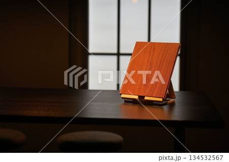 Book displayed on a table, restaurant menu, guestbook or exhibition catalogue 134532567