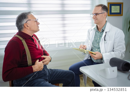 Doctor engages in conversation with patient in modern clinic setting Doctor engages in conversation with patient in modern clinic setting 134532851