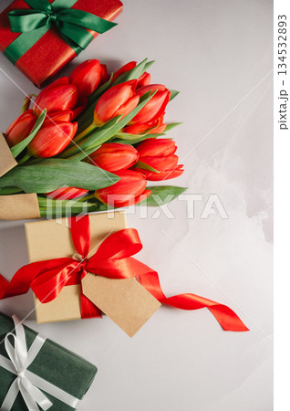 Mothers' day. Red tulips with gift boxes. Easter holiday. Bright background, copy space. Mothers' day. Red tulips with gift boxes. Easter holiday. Bright background, copy space. 134532893